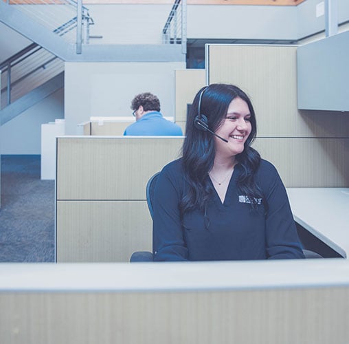 Woman-in-cubicle-on-headset